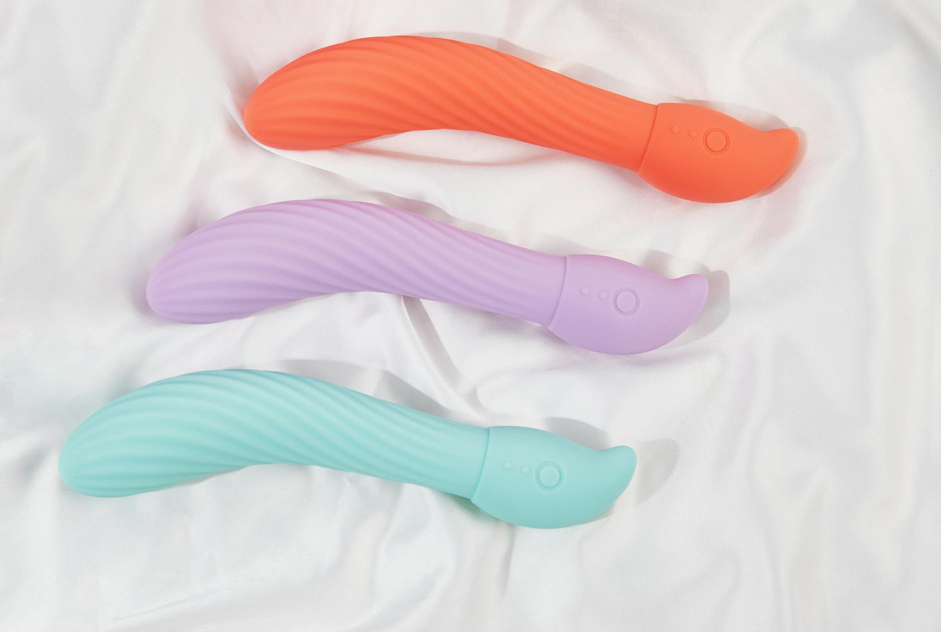 Woman holding a vibrator with contemplative expression, representing self-care and stress relief
