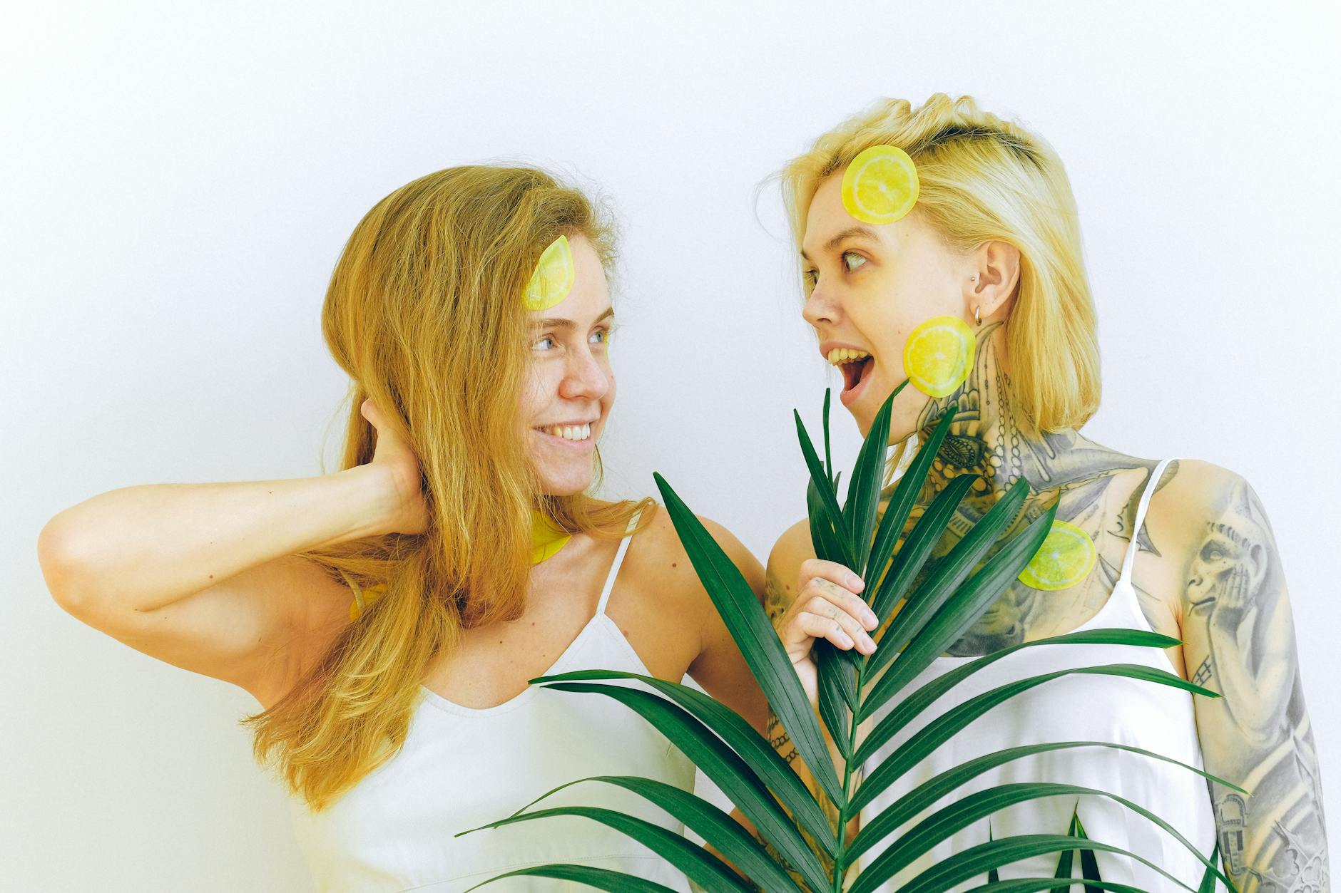 Two women smiling and laughing together, showing joy and relaxation while managing stress naturally